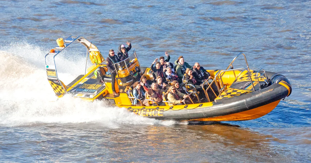 A Thames RIB speedboat with passengers in life jackets on the River Thames